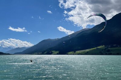 Downhill, kiten, fliegen: Aktivurlaub im Vinschgau - Hotspot des Wassersports mit Lenkdrachen: ein Kitesurfer auf dem Reschensee.