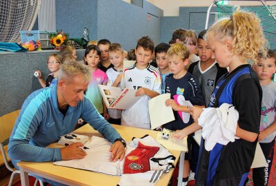 Großer Bahnhof in Limbach: Fußball-Weltmeister zu Gast am "Jahnhaus" - Am Ende des Sporttages musste Pierre Littbarski unzählige Autogramme schreiben - durchaus auch auf Trikots, Schuhe und Fußbälle. Foto: A. Büchner