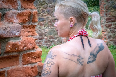 Mit Herz und Huf: Wie Fannys (41) Tattoos ihre Großeltern und Pferde verewigen - Eine ihrer größten Leidenschaften sind Pferde - so ließ sie sich 2020 eine greifende Hand und einen Pferdehuf auf dem oberen Rücken stechen.