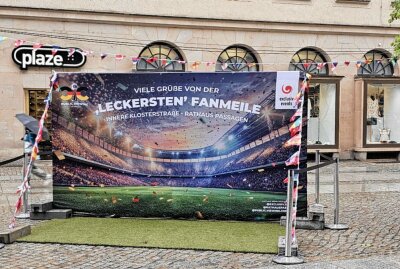 Public Viewing in der Chemnitzer City: Fußballfans trotzen dem Regen - Trotz des ungemütlichen Regenwetters ließen es sich die begeisterten Fans nicht nehmen, das spannende Spiel der deutschen Mannschaft gegen Ungarn auf der großen Leinwand zu verfolgen. Foto: Harry Härtel
