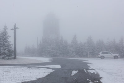 Winterauftakt im Erzgebirge: Schnee auf Fichtelberg und Winterdienst im Einsatz - Touristen und Touristinnen brauchten diesmal eine dicke Jacke, Mütze und einen Schal. Einige Gäste genießen bereits den ersten Schnee.